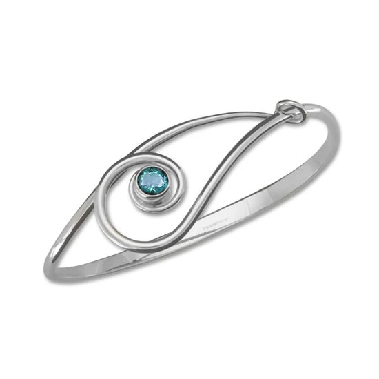 Photo of "Sliding Clef" Bracelet in a decorative scene, designed by , available at Plumb Gold & Plumb Silver