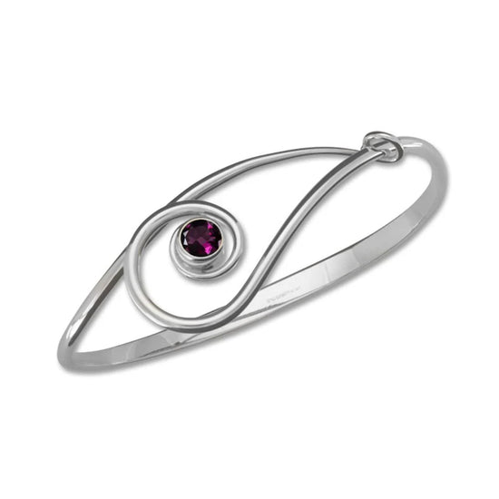 Photo of "Sliding Clef" Bracelet in a decorative scene, designed by , available at Plumb Gold & Plumb Silver