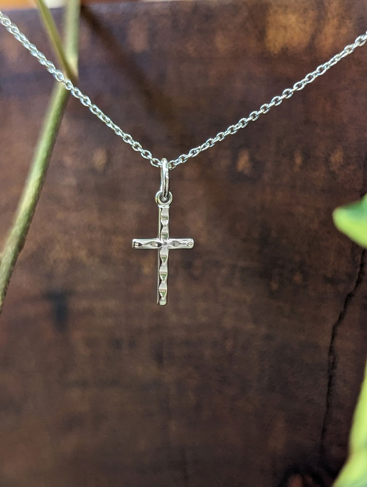 Photo of Small Faceted Cross in a decorative scene, designed by , available at Plumb Gold & Plumb Silver