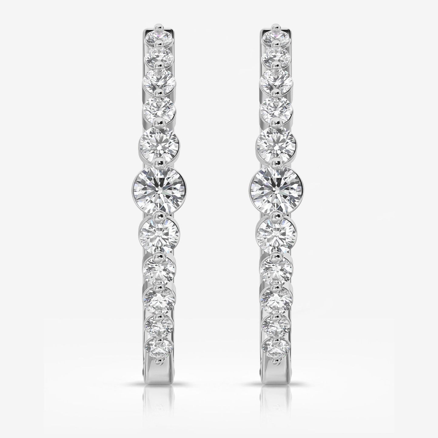 Photo of "Sonya" Diamond Hoops in a decorative scene, designed by , available at Plumb Gold & Plumb Silver