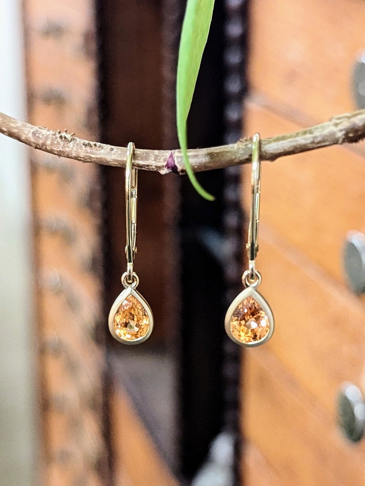 Photo of Spessartite Garnet dangles in a decorative scene, designed by , available at Plumb Gold & Plumb Silver