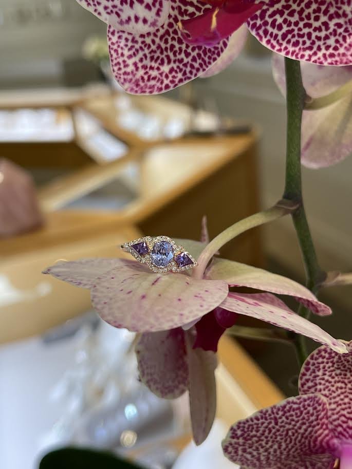Photo of Spinel and Sapphire Trio Ring in a decorative scene, designed by , available at Plumb Gold & Plumb Silver