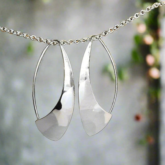 Photo of "Spinnaker" Earrings in a decorative scene, designed by , available at Plumb Gold & Plumb Silver