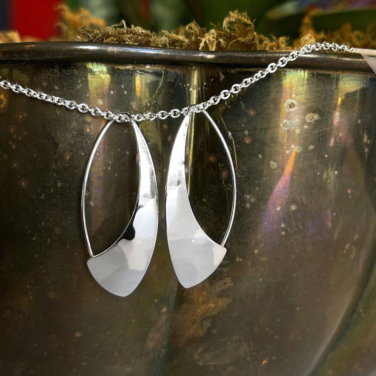 Photo of "Spinnaker" Earrings in a decorative scene, designed by , available at Plumb Gold & Plumb Silver