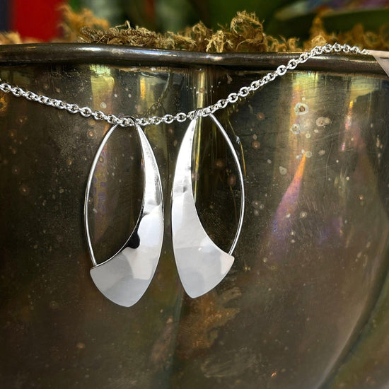 Photo of "Spinnaker" Earrings in a decorative scene, designed by , available at Plumb Gold & Plumb Silver