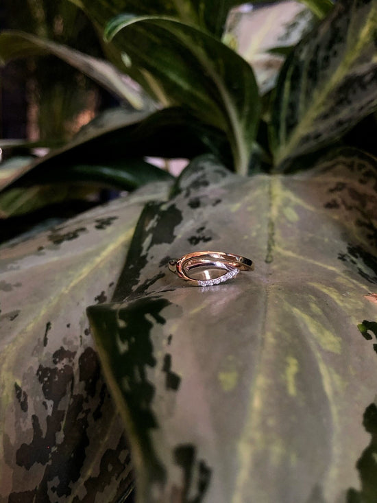 Photo of Spiral Teardrop Ring in a decorative scene, designed by , available at Plumb Gold & Plumb Silver