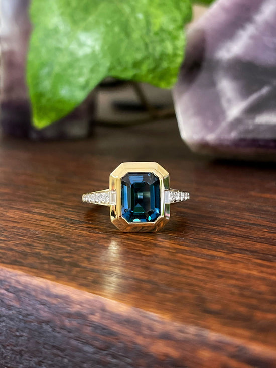 Photo of Stanton Color London Blue Topaz Ring in a decorative scene, designed by , available at Plumb Gold & Plumb Silver
