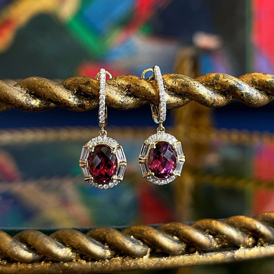 Photo of Stanton Color Rhodolite Garnet Dangles in a decorative scene, designed by , available at Plumb Gold & Plumb Silver