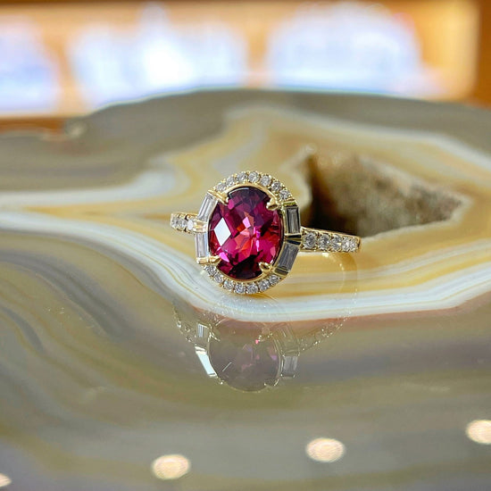 Photo of Stanton Color Rhodolite Garnet Ring in a decorative scene, designed by , available at Plumb Gold & Plumb Silver