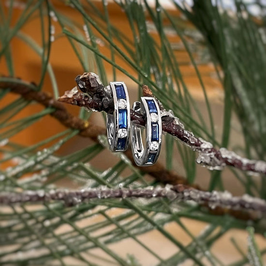 Photo of Stanton Color Sapphire and Diamond Hoops in a decorative scene, designed by , available at Plumb Gold & Plumb Silver