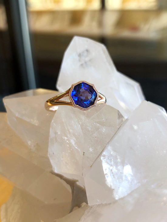 Photo of Stanton Color Tanzanite Ring in a decorative scene, designed by , available at Plumb Gold & Plumb Silver