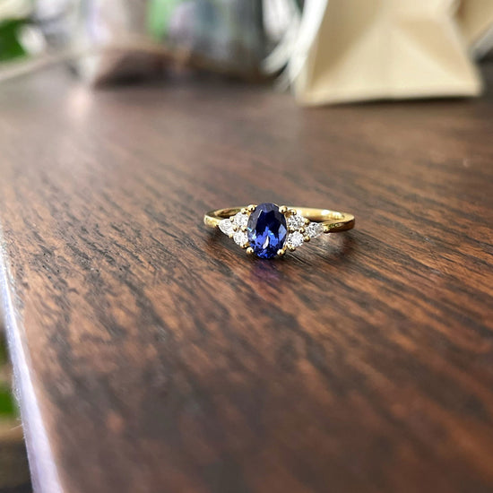 Photo of Stanton Color Tanzanite and Diamond Ring in a decorative scene, designed by , available at Plumb Gold & Plumb Silver