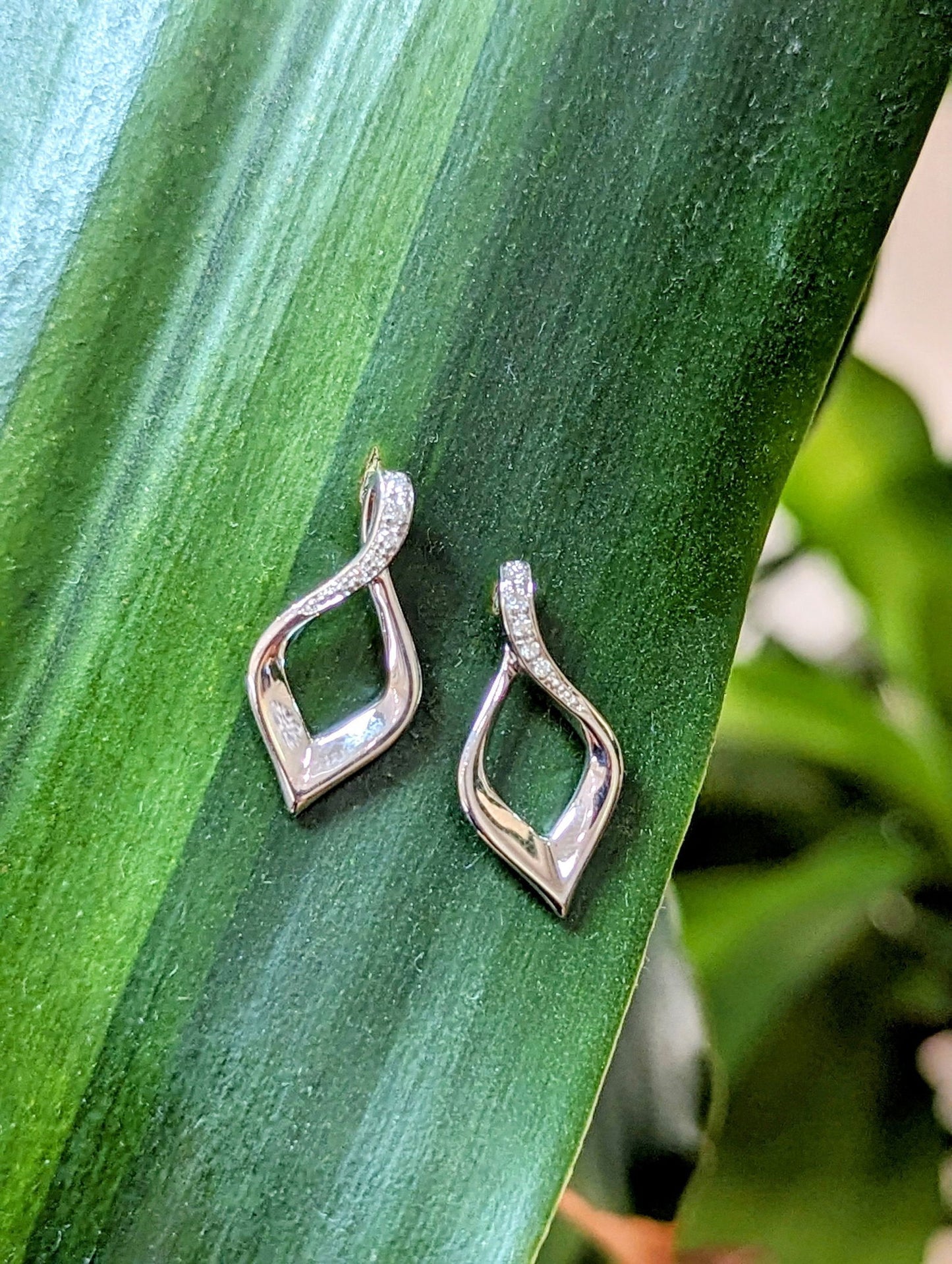 Photo of Sterling Diamond Accented Twist Earring in a decorative scene, designed by , available at Plumb Gold & Plumb Silver