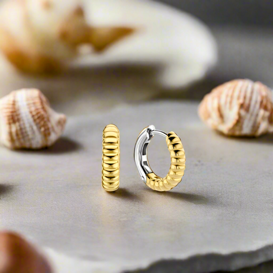 Photo of Sterling Silver Gold Plated Shell Huggies in a decorative scene, designed by , available at Plumb Gold & Plumb Silver