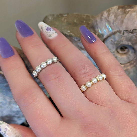 Photo of Sterling Silver Simulated Pearl Stackable Ring in a decorative scene, designed by , available at Plumb Gold & Plumb Silver