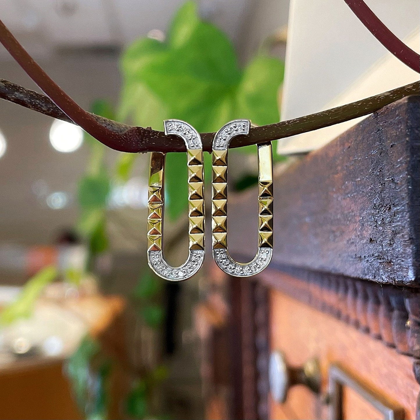Photo of Studded Oval Earrings in a decorative scene, designed by , available at Plumb Gold & Plumb Silver
