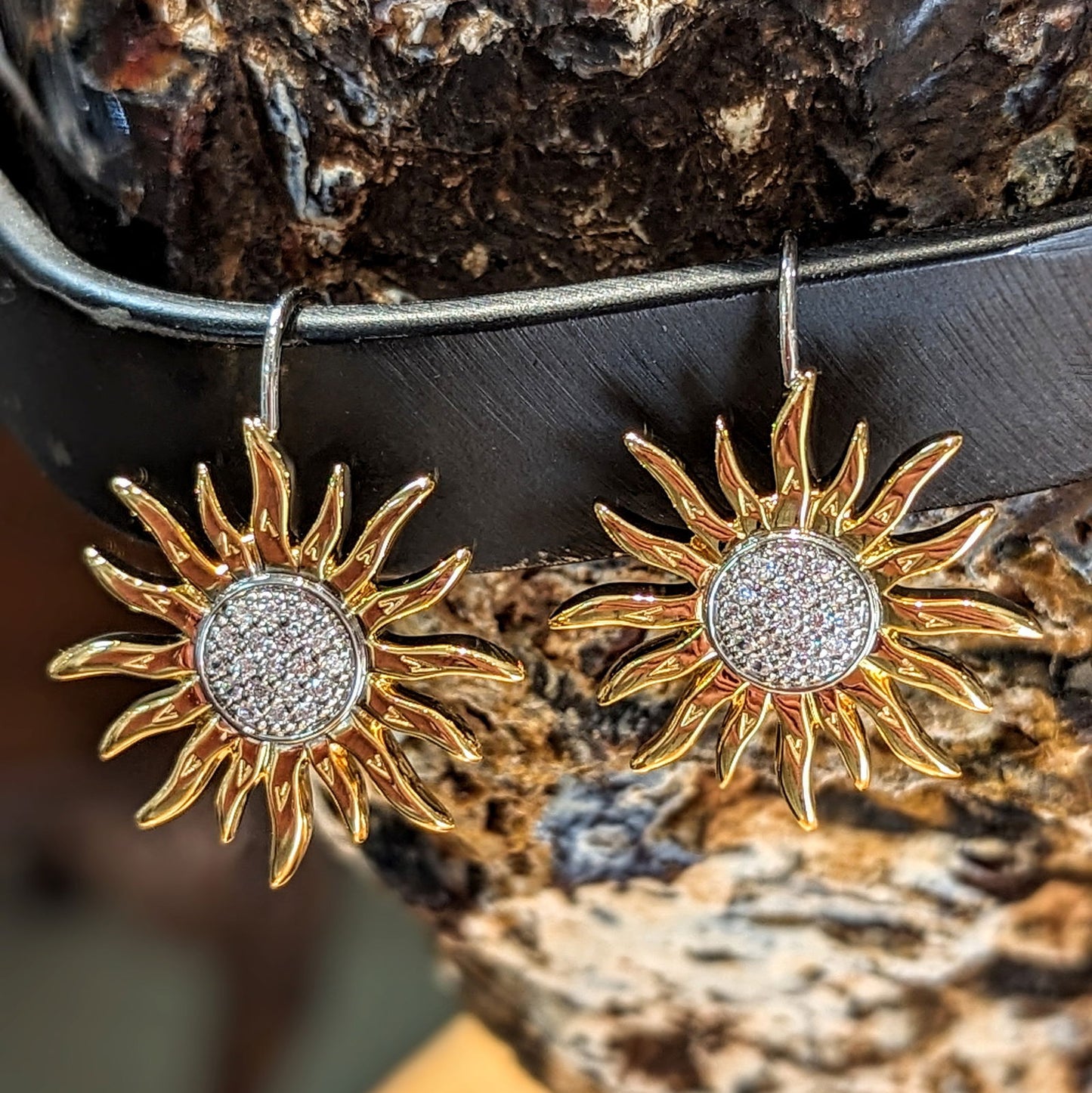 Photo of Sunflower Earring in a decorative scene, designed by , available at Plumb Gold & Plumb Silver