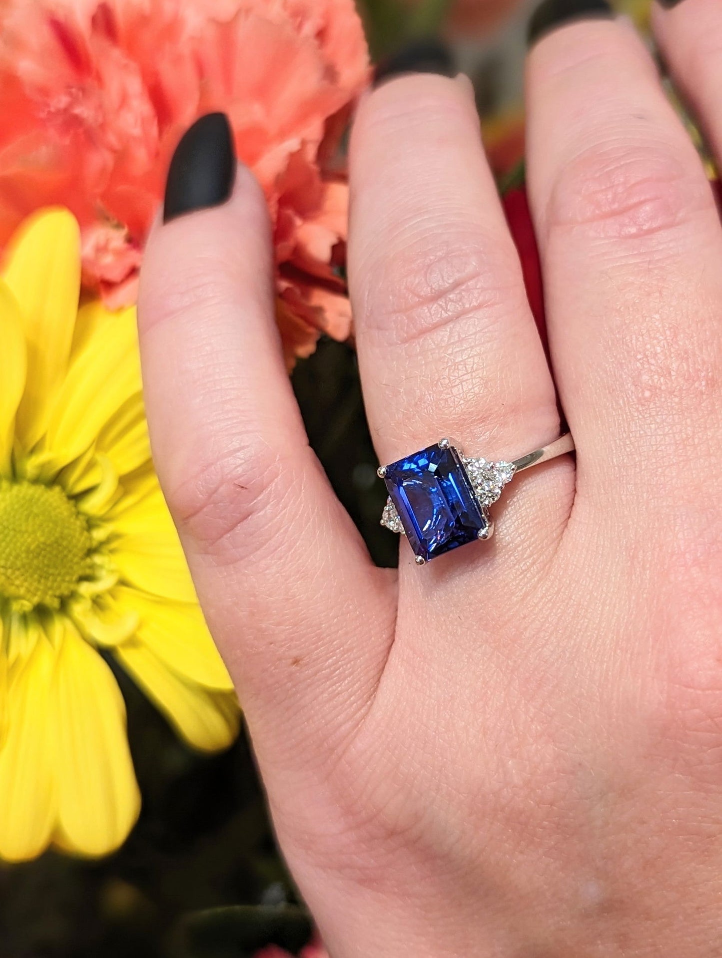 Photo of Tanzanite and Diamond Accented Ring in a decorative scene, designed by , available at Plumb Gold & Plumb Silver