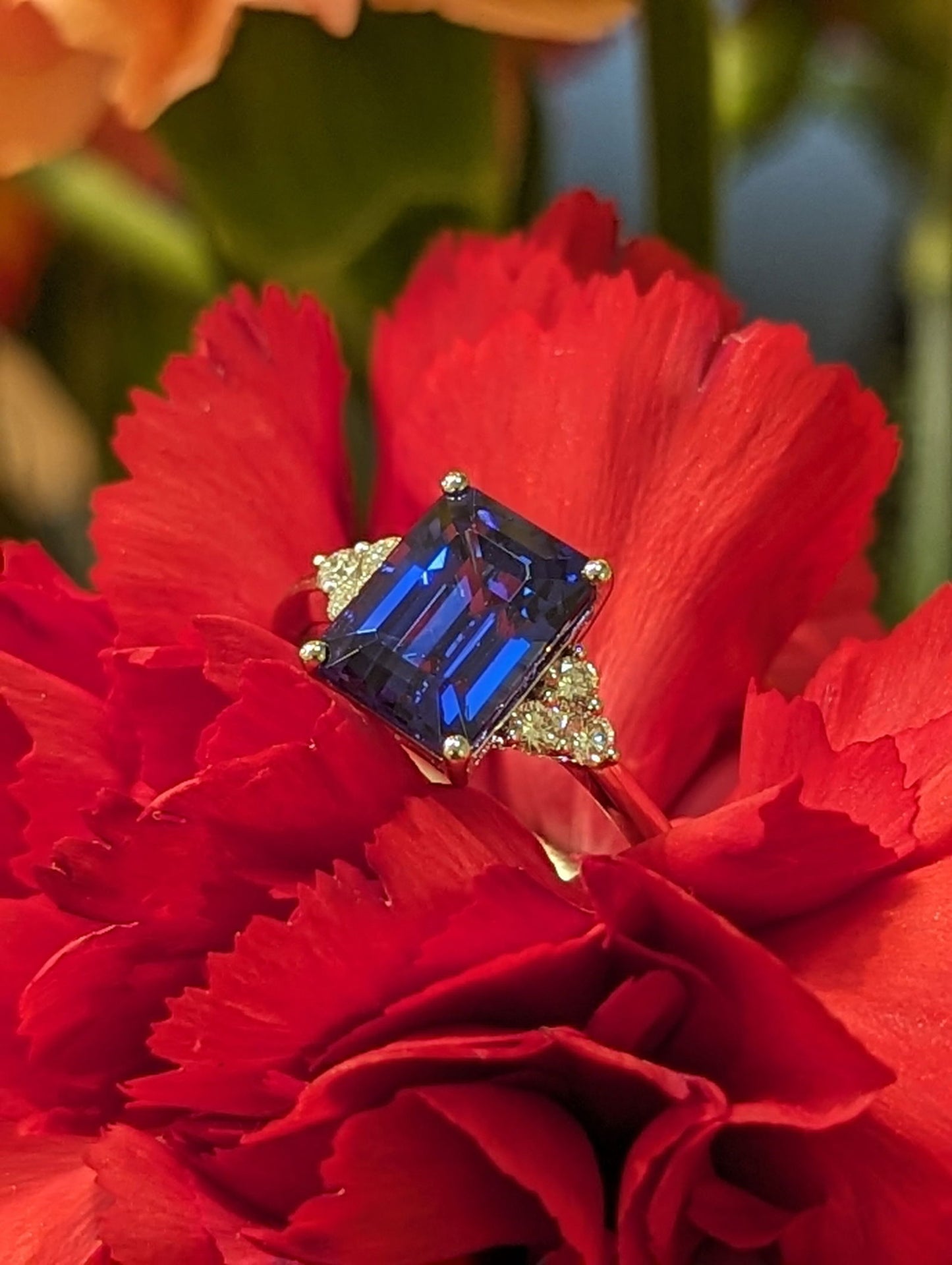Photo of Tanzanite and Diamond Accented Ring in a decorative scene, designed by , available at Plumb Gold & Plumb Silver