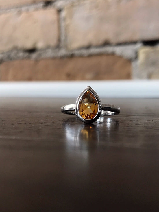 Photo of Teardrop Citrine Ring in a decorative scene, designed by , available at Plumb Gold & Plumb Silver