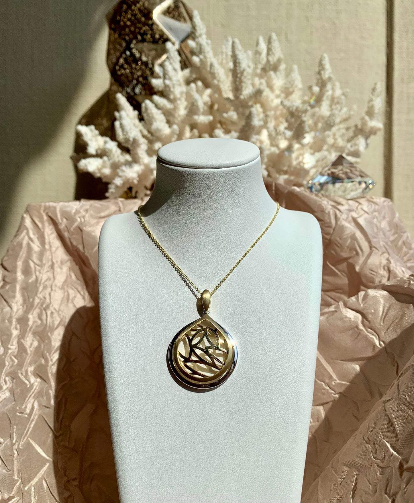 Photo of Teardrop Leaf Pendant in a decorative scene, designed by , available at Plumb Gold & Plumb Silver