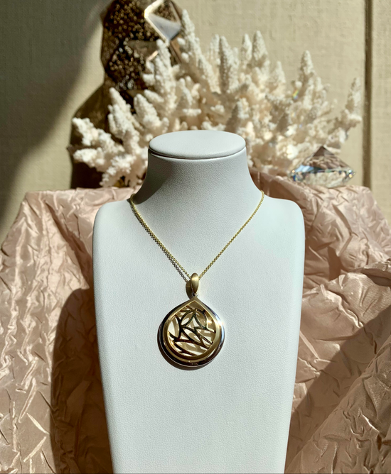 Photo of Teardrop Leaf Pendant in a decorative scene, designed by , available at Plumb Gold & Plumb Silver