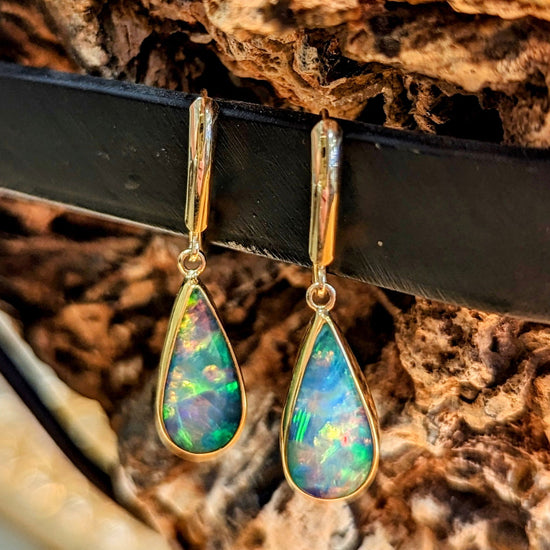 Photo of Teardrop Opal Dangles in a decorative scene, designed by , available at Plumb Gold & Plumb Silver