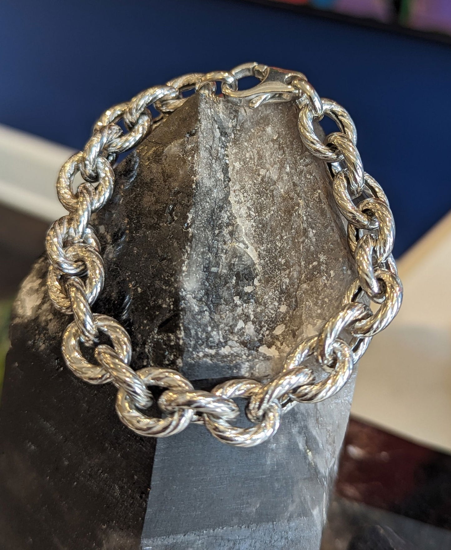 Photo of Textured Rope Link Bracelet in a decorative scene, designed by , available at Plumb Gold & Plumb Silver