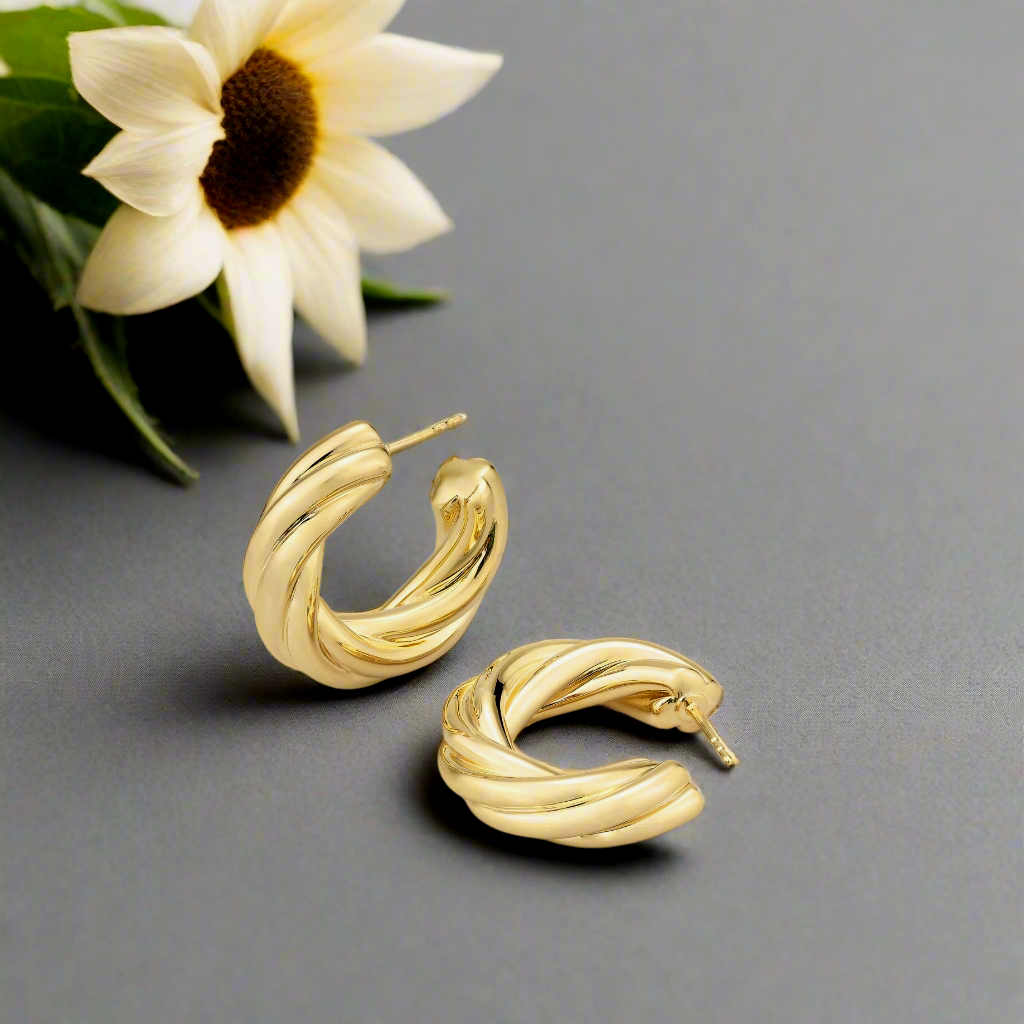 Photo of Thick Twisted Hoop in a decorative scene, designed by , available at Plumb Gold & Plumb Silver