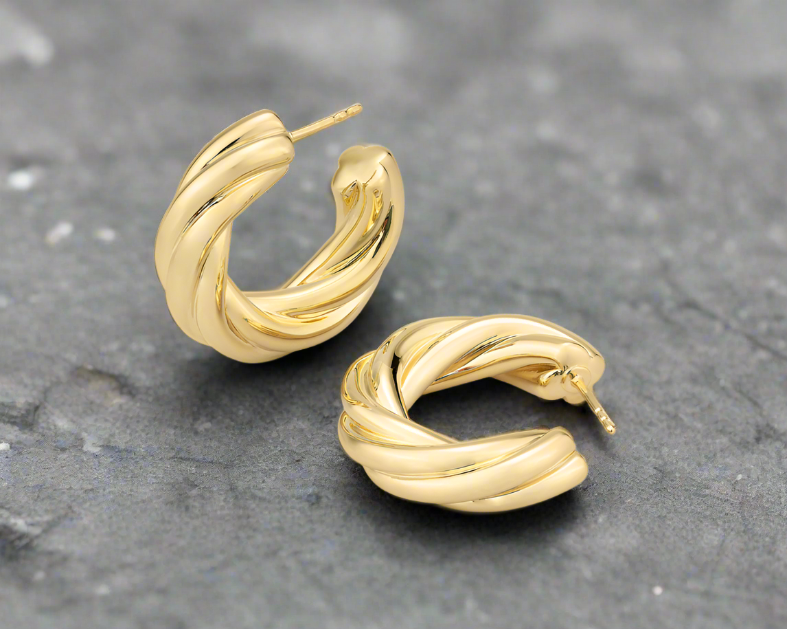 Photo of Thick Twisted Hoop in a decorative scene, designed by , available at Plumb Gold & Plumb Silver
