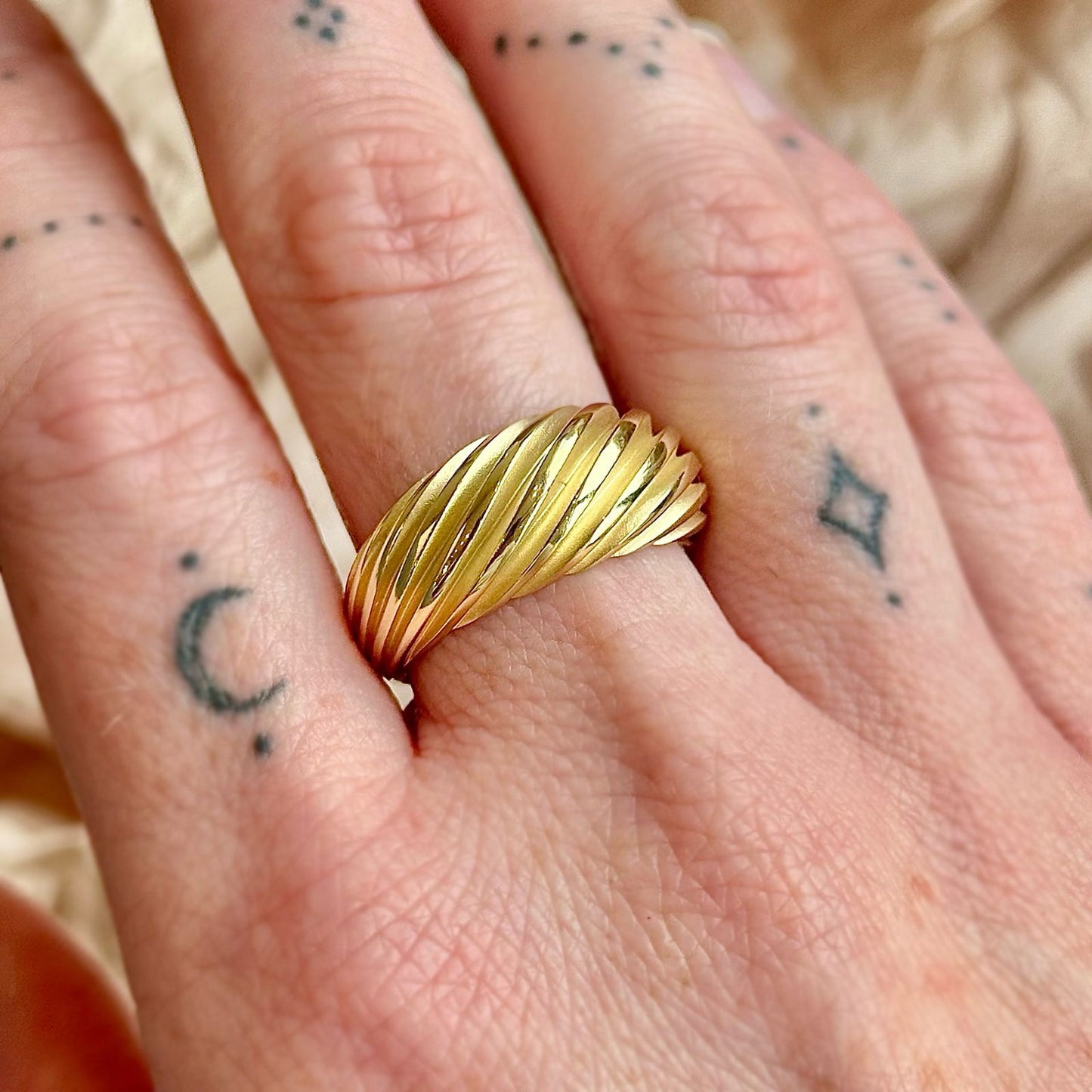 Photo of Thick Wave Ring in a decorative scene, designed by -, available at Plumb Gold & Plumb Silver