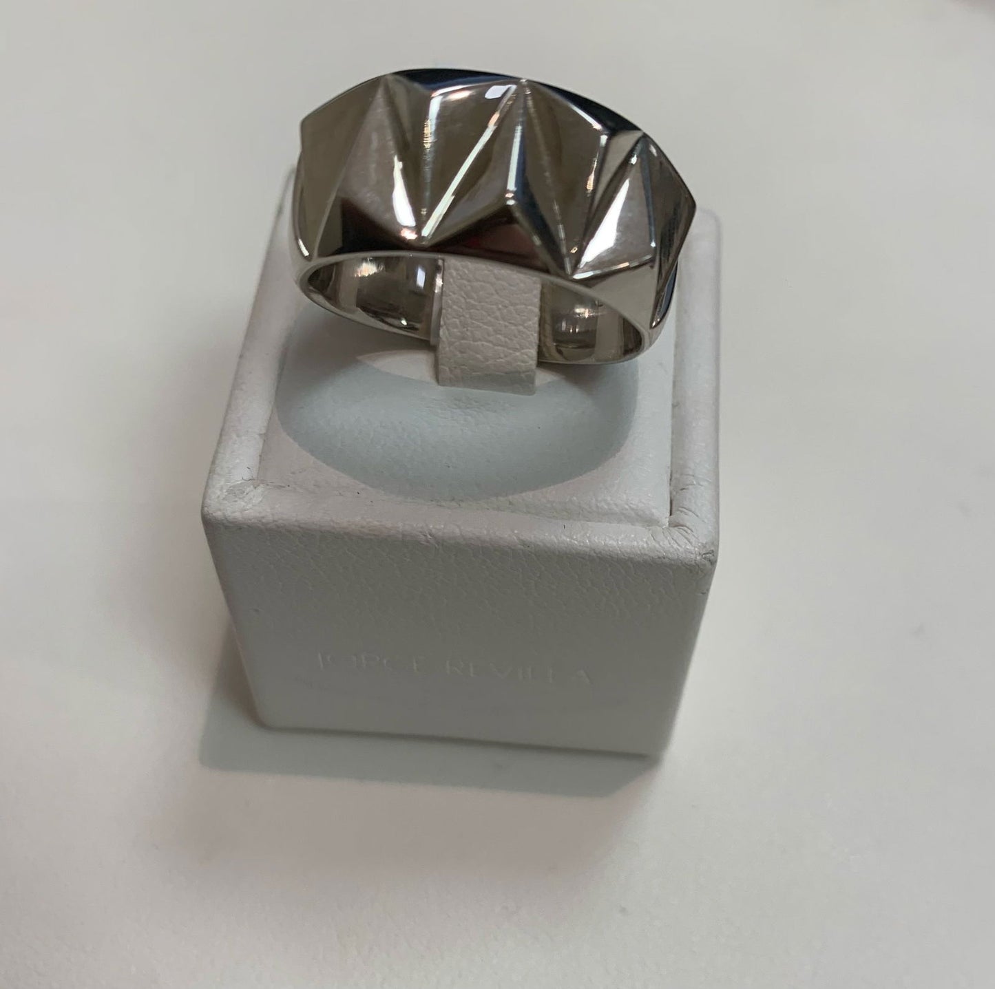Photo of Ti Sento Geometric Ring in a decorative scene, designed by , available at Plumb Gold & Plumb Silver
