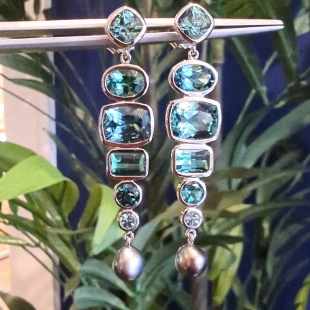 Photo of Tourmaline Dangle Earrings in a decorative scene, designed by , available at Plumb Gold & Plumb Silver