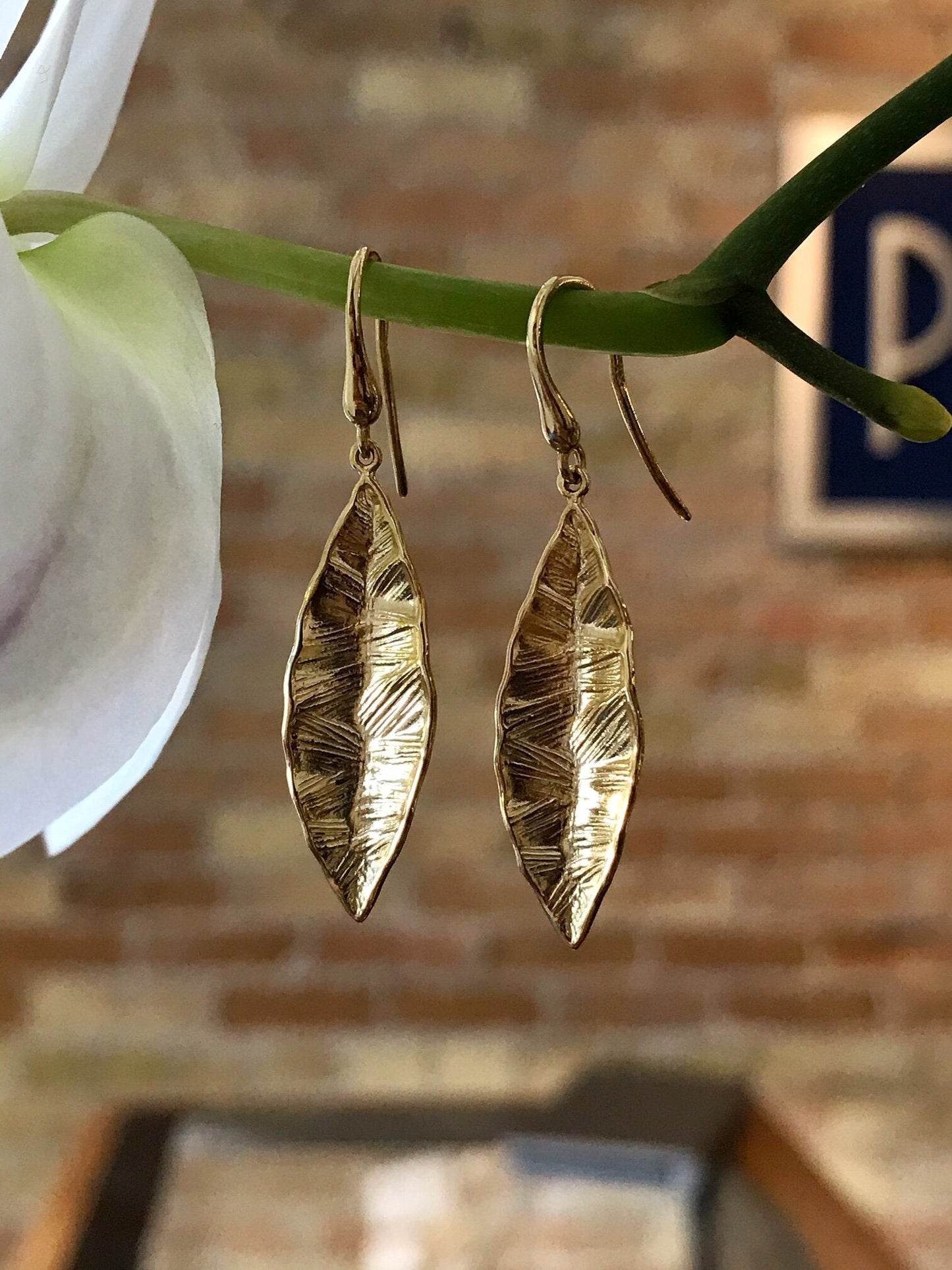 Photo of Tropical Leaf Dangles in a decorative scene, designed by , available at Plumb Gold & Plumb Silver