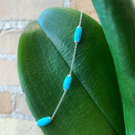 Photo of Turquoise Station Bracelet in a decorative scene, designed by , available at Plumb Gold & Plumb Silver