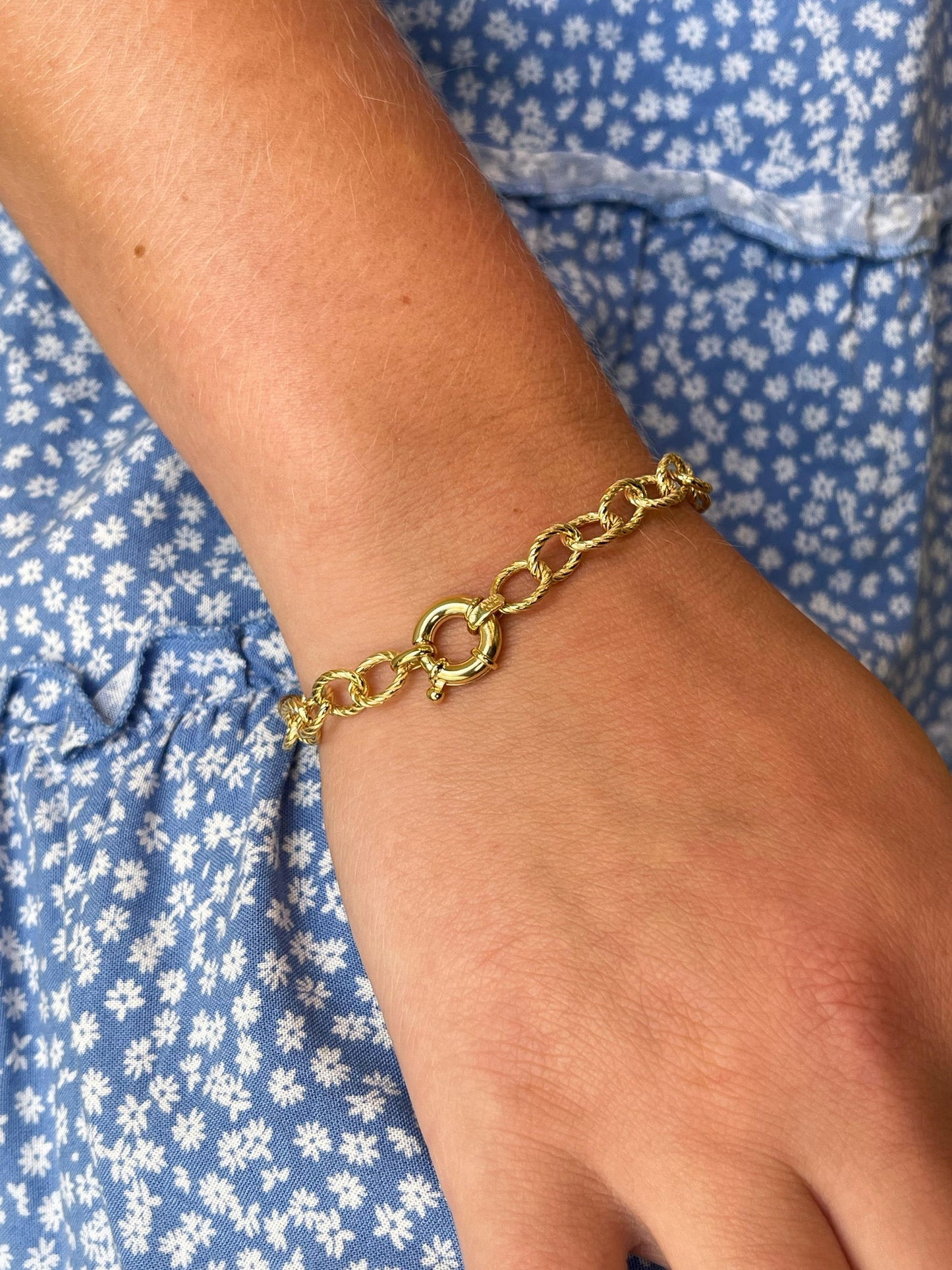 Photo of Twisted Rope Bracelet in a decorative scene, designed by , available at Plumb Gold & Plumb Silver