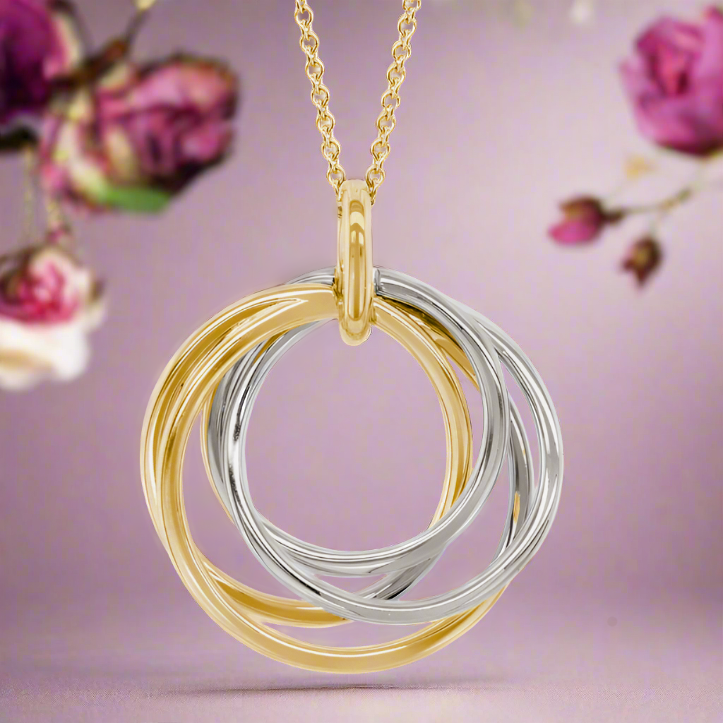 Photo of Twisting Circles Pendant in a decorative scene, designed by , available at Plumb Gold & Plumb Silver