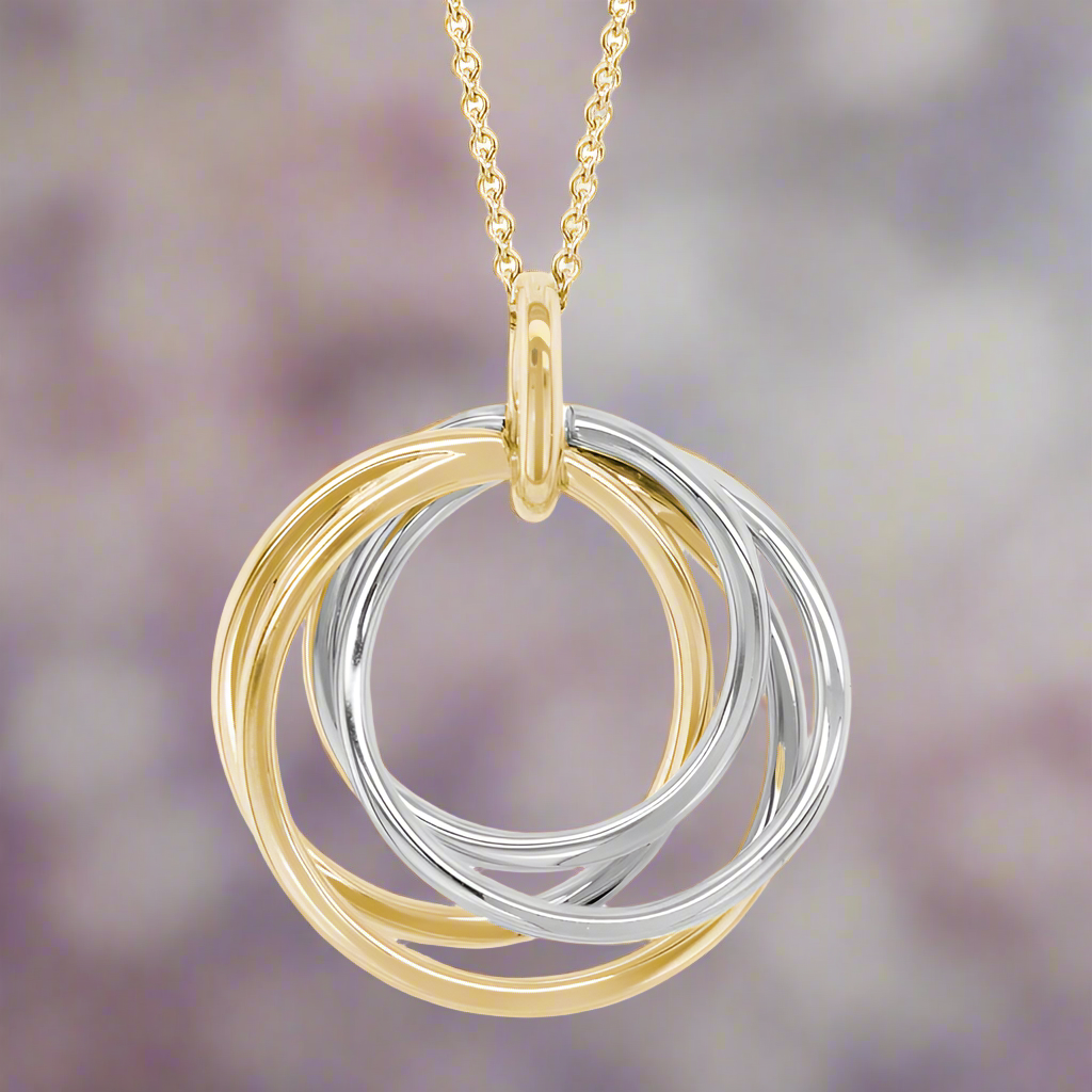 Photo of Twisting Circles Pendant in a decorative scene, designed by , available at Plumb Gold & Plumb Silver