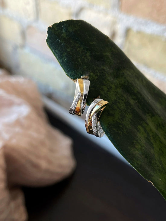 Photo of Two-Tone Sapphire Huggies in a decorative scene, designed by , available at Plumb Gold & Plumb Silver