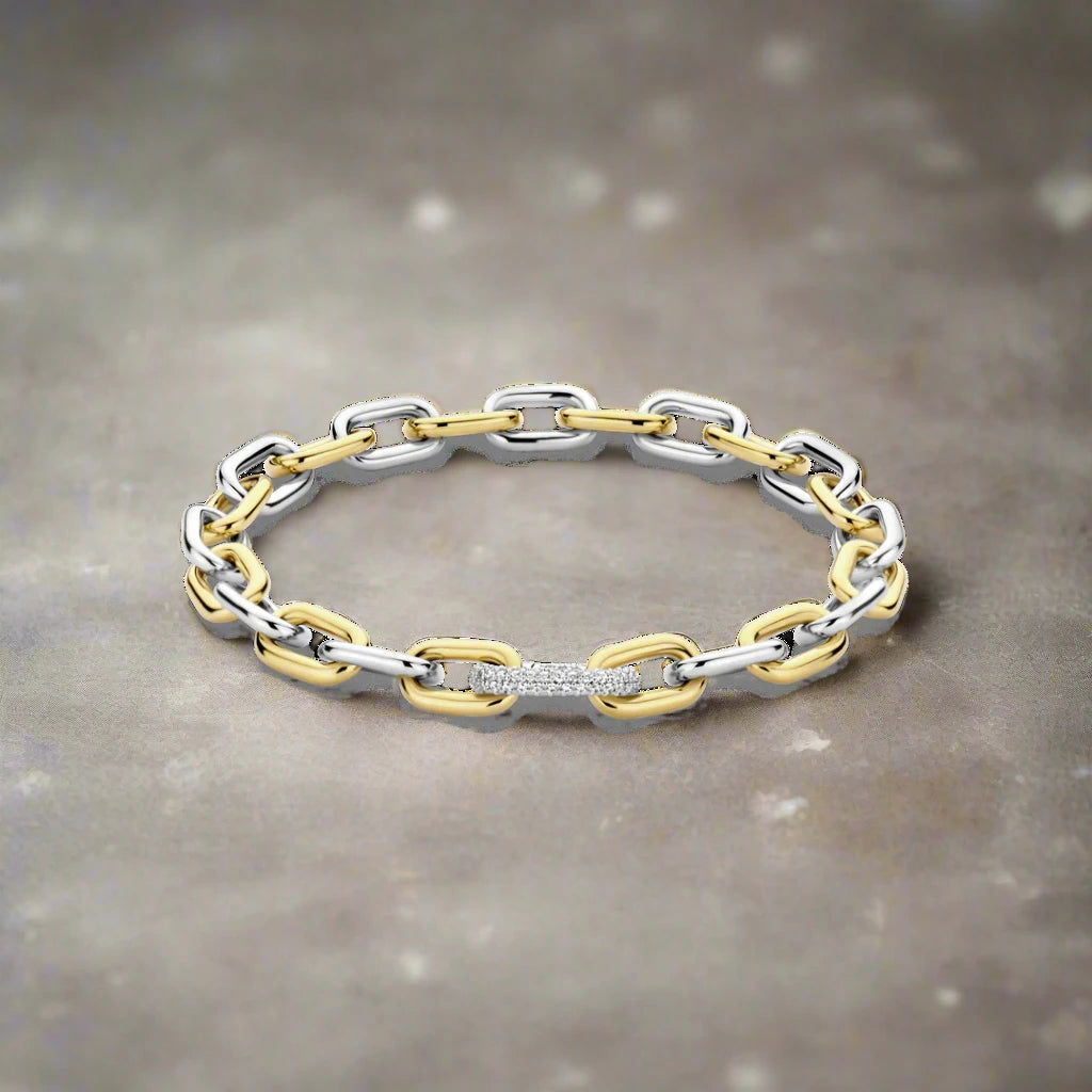 Photo of Two Tone Cable Bracelet in a decorative scene, designed by -, available at Plumb Gold & Plumb Silver