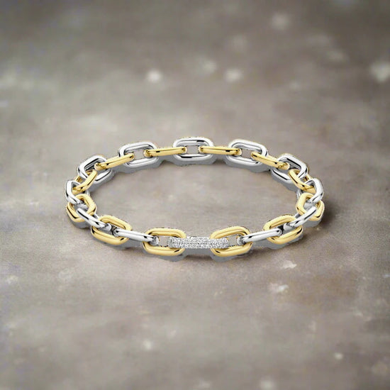 Photo of Two Tone Cable Bracelet in a decorative scene, designed by -, available at Plumb Gold & Plumb Silver