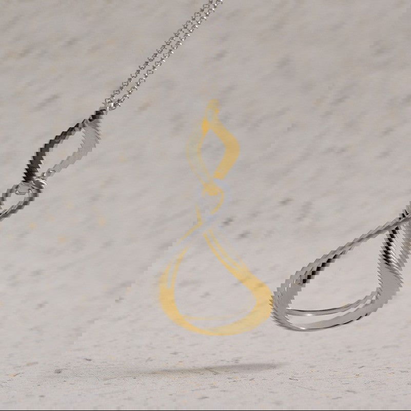 Photo of “Venice” Two Tone Pendant in a decorative scene, designed by , available at Plumb Gold & Plumb Silver