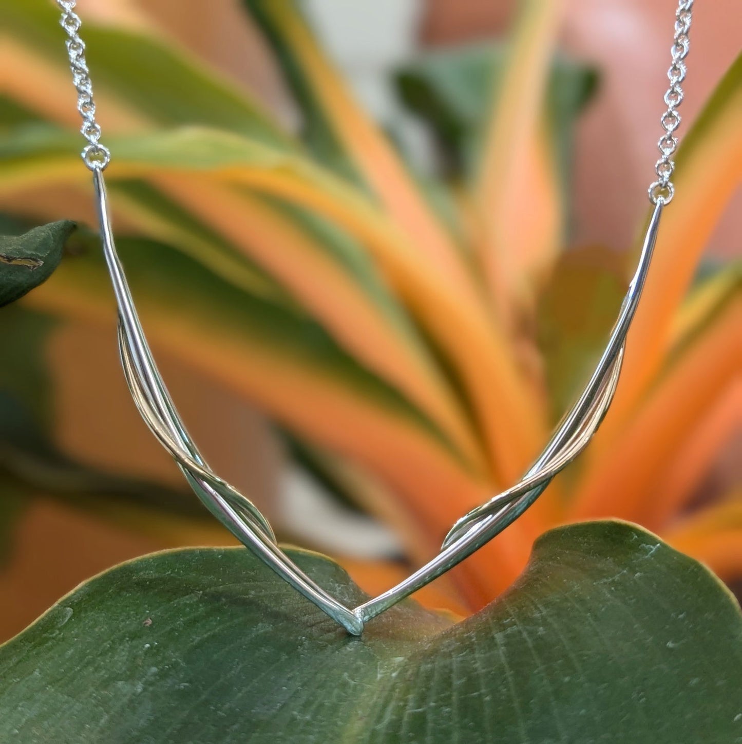 Photo of "Vineyard Swing" Necklace in a decorative scene, designed by , available at Plumb Gold & Plumb Silver