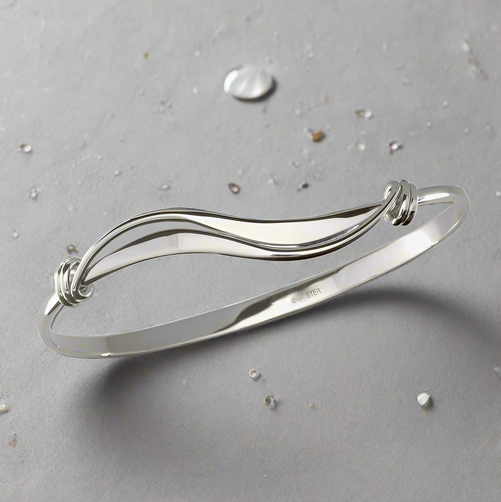 Photo of "Wave" Bracelet in a decorative scene, designed by , available at Plumb Gold & Plumb Silver