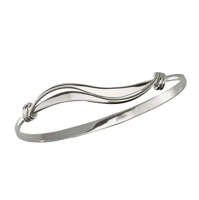 Photo of "Wave" Bracelet in a decorative scene, designed by , available at Plumb Gold & Plumb Silver