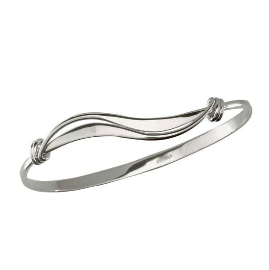 Photo of "Wave" Bracelet in a decorative scene, designed by , available at Plumb Gold & Plumb Silver