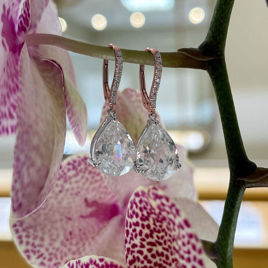 Photo of White Zircon and Diamond Dangles in a decorative scene, designed by -, available at Plumb Gold & Plumb Silver