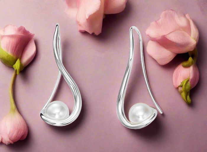 Photo of "Wind Spinner" Earrings in a decorative scene, designed by , available at Plumb Gold & Plumb Silver