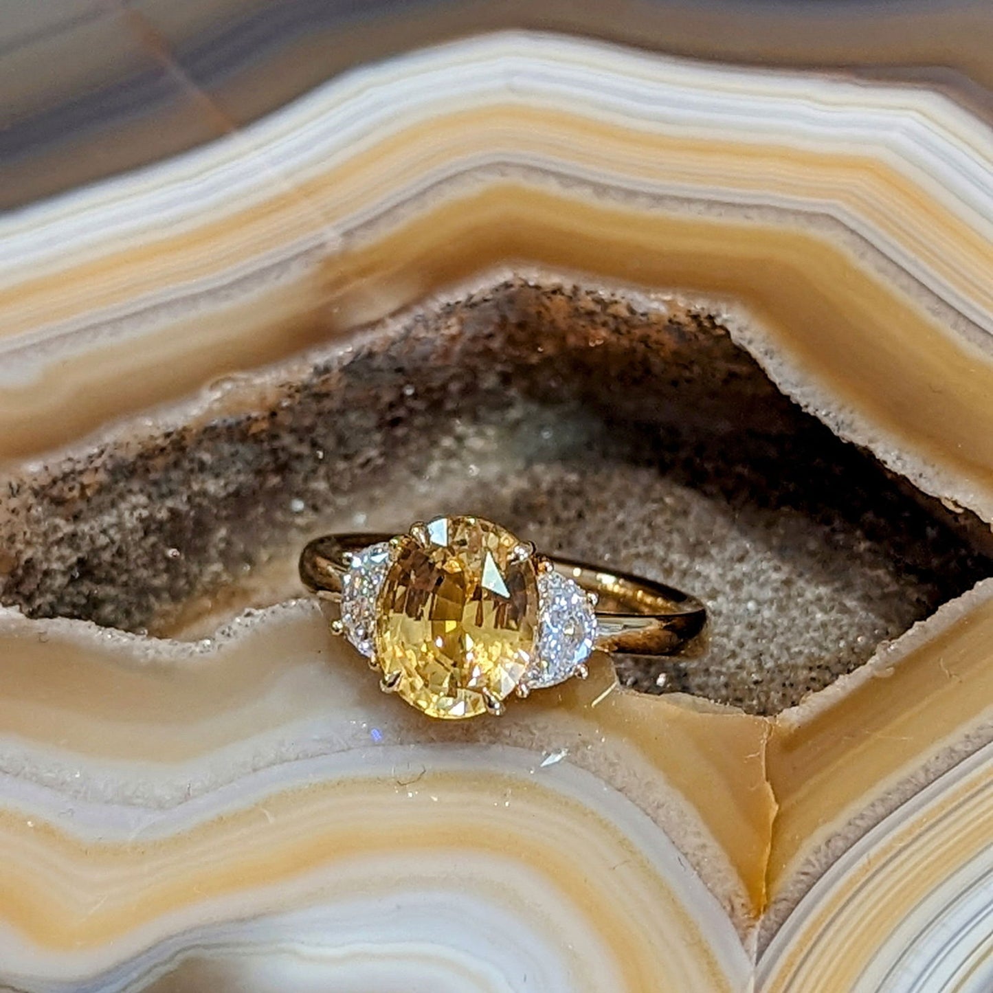 Photo of Yellow Sapphire and Diamond Ring in a decorative scene, designed by , available at Plumb Gold & Plumb Silver