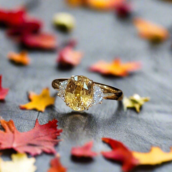 Photo of Yellow Sapphire and Diamond Ring in a decorative scene, designed by , available at Plumb Gold & Plumb Silver